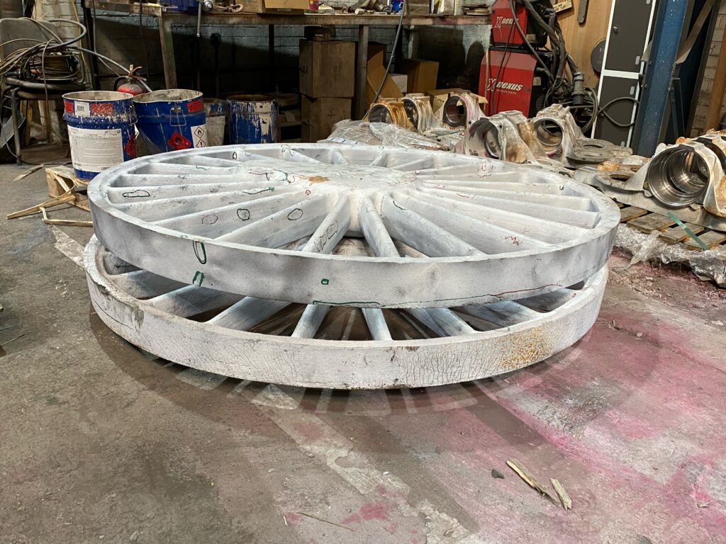 The two new wheel castings sit coated in developing solution